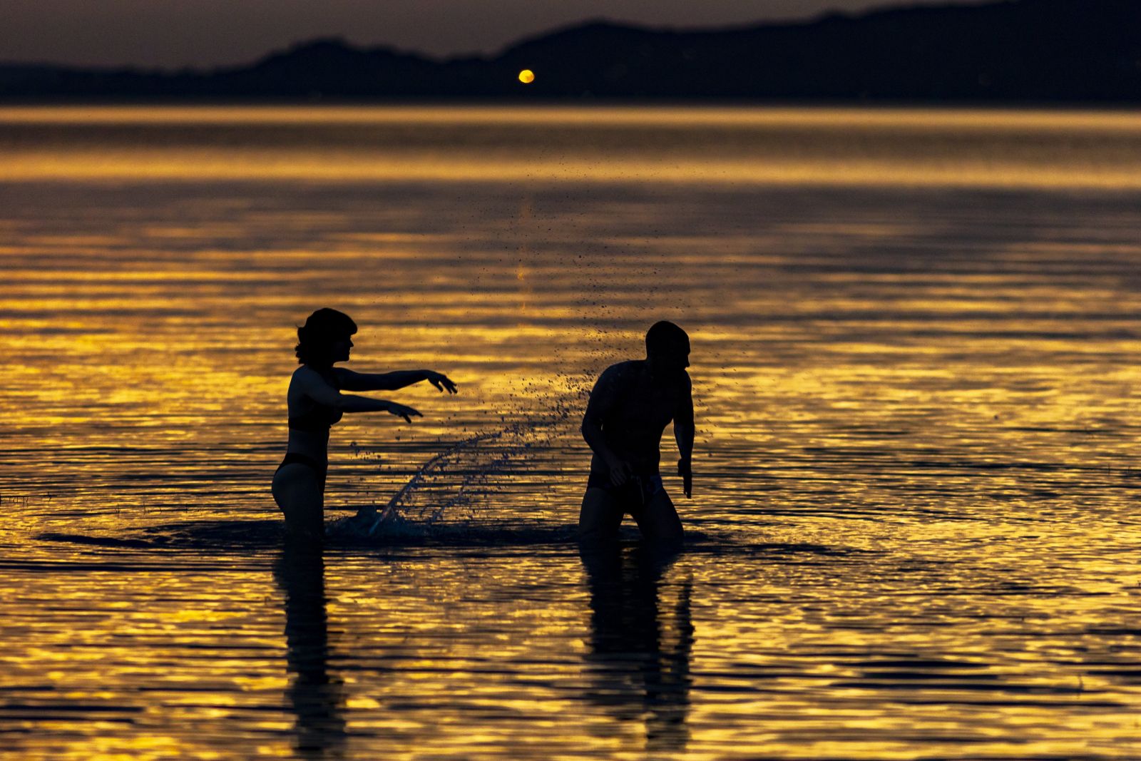 Fürdőzők a Balatonban a balatonfenyvesi szabadstrandon. Balaton naplemente vízminőség strand szabadvízi strand fürdőzés nyár szezon 2022 Velencei-tó Duna biztonság szabadstrand