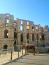Az El Jemben található építmény a római kor harmadik legnagyobb amfiteátrumának számított, majdnem akkora volt, mint a római Colosseum.
